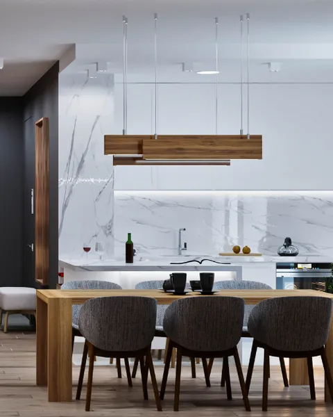 Open-plan dining space designed by Avinya Projects, with a walnut-wood pendant fixture and marble backsplash